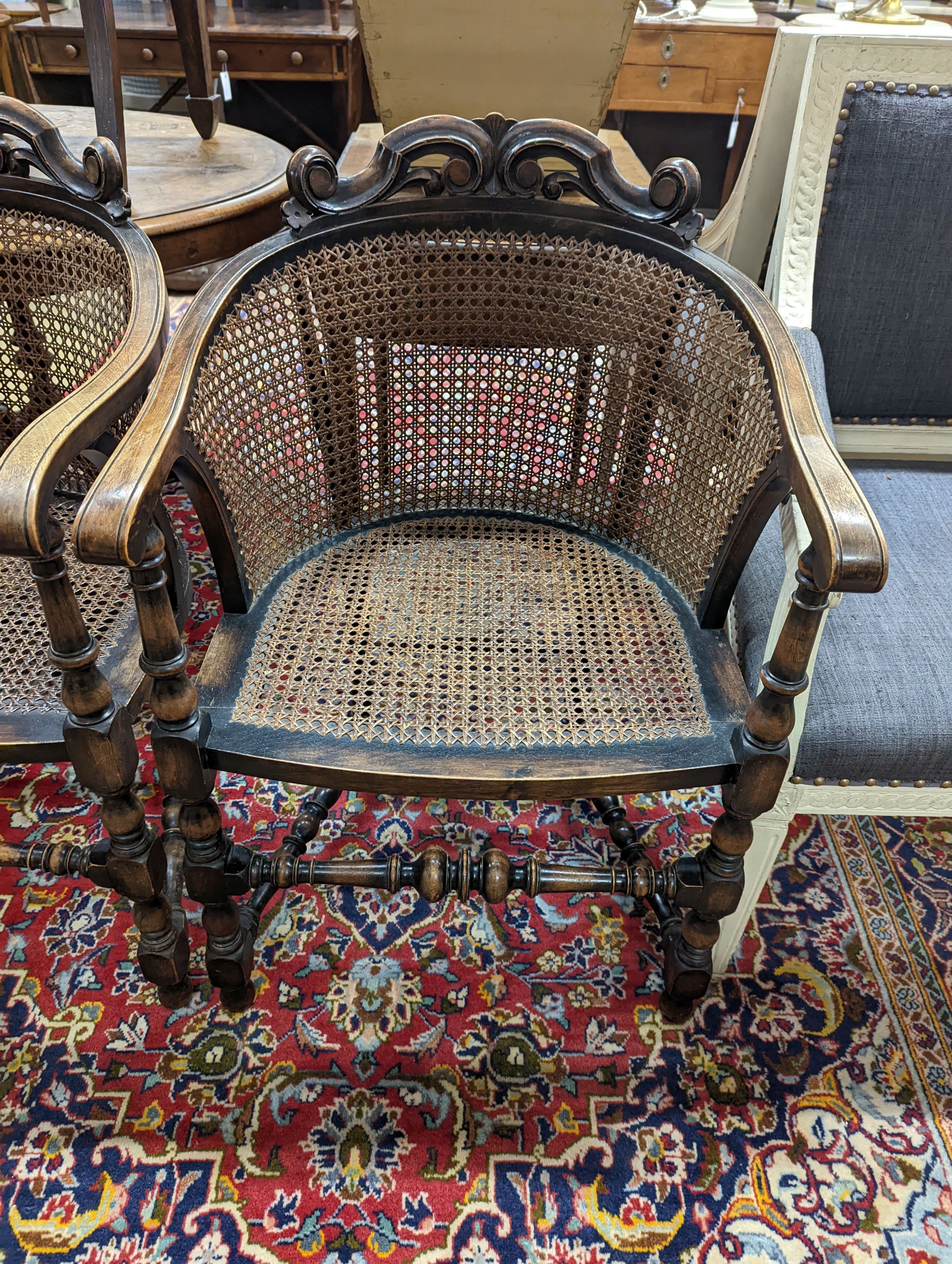 A pair of early 20th century Carolean style caned beech tub framed chairs, width 56cm, depth 48cm, height 85cm